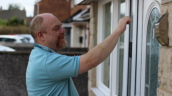 Wayne Street knocking on a door
